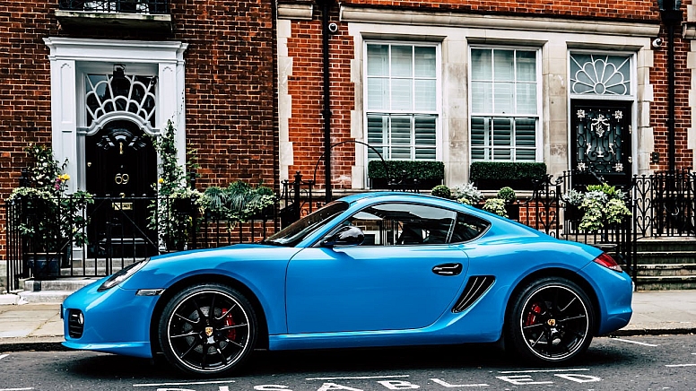 blue coupe on road