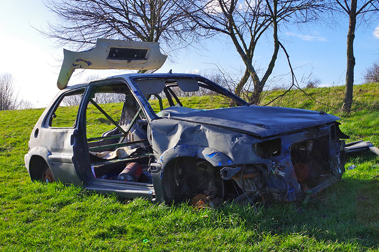A stolen burnt-out car in a field